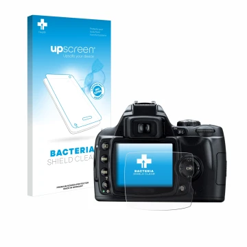 Parte frontal de un envase de producto con el logotipo de la marca upscreen. Al lado se muestra el dispositivo Nikon D40 con s