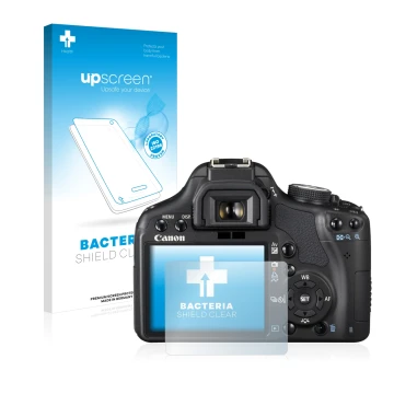 Parte frontal de un envase de producto con el logotipo de la marca upscreen. Al lado se muestra el dispositivo Canon EOS 500D 