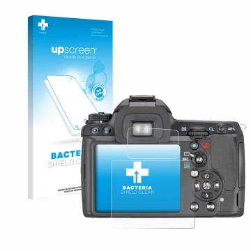 Parte frontal de un envase de producto con el logotipo de la marca upscreen. Al lado se muestra el dispositivo Pentax K7, K-7 