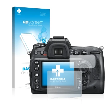 Parte frontal de un envase de producto con el logotipo de la marca upscreen. Al lado se muestra el dispositivo Nikon D300S con