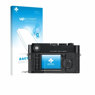 Parte frontal de un envase de producto con el logotipo de la marca upscreen. Al lado se muestra el dispositivo Leica M9 con su