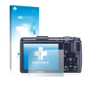 Parte frontal de un envase de producto con el logotipo de la marca upscreen. Al lado se muestra el dispositivo Ricoh GR Digita