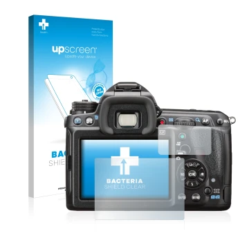 Parte frontal de un envase de producto con el logotipo de la marca upscreen. Al lado se muestra el dispositivo Pentax K-3 II c