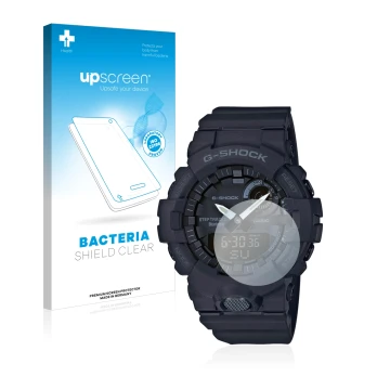 Parte frontal de un envase de producto con el logotipo de la marca upscreen. Al lado se muestra el dispositivo Casio G-Shock G