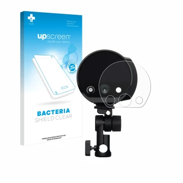 Parte frontal de un envase de producto con el logotipo de la marca upscreen. Al lado se muestra el dispositivo Profoto B10X co