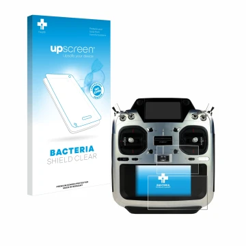 Parte frontal de un envase de producto con el logotipo de la marca upscreen. Al lado se muestra el dispositivo Futaba T26SZ co